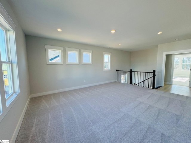 carpeted spare room featuring a healthy amount of sunlight