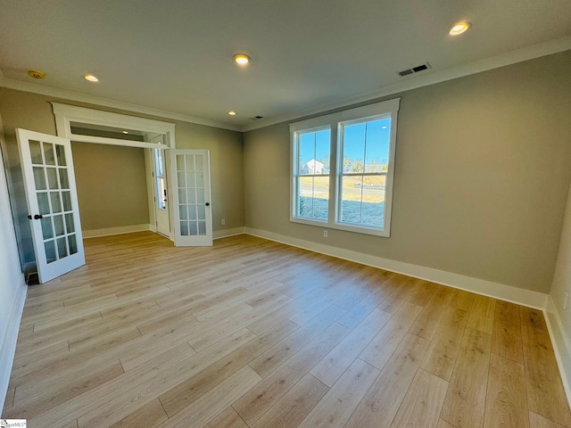 spare room featuring french doors, light hardwood / wood-style flooring, and crown molding