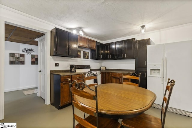 kitchen featuring dark brown cabinets, white appliances, and a textured ceiling