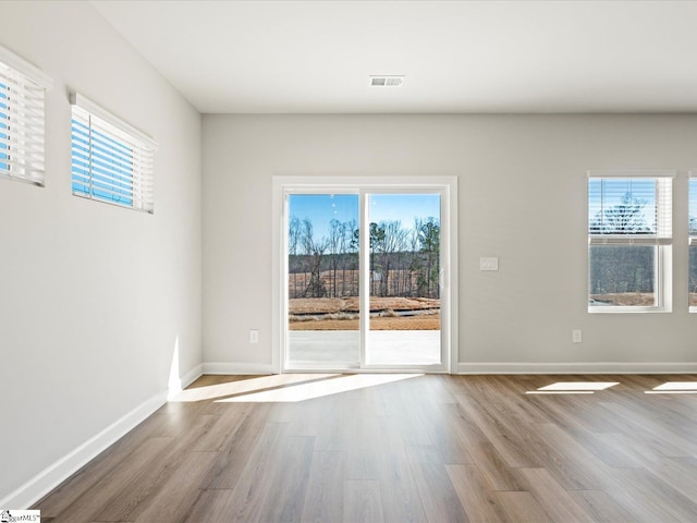 interior space with wood finished floors and a wealth of natural light