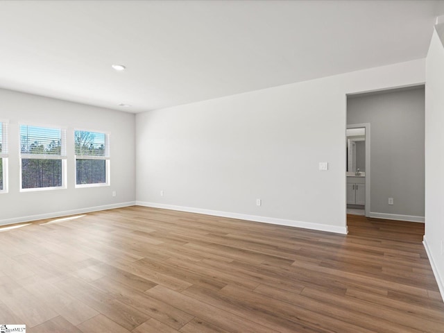 empty room featuring baseboards and wood finished floors