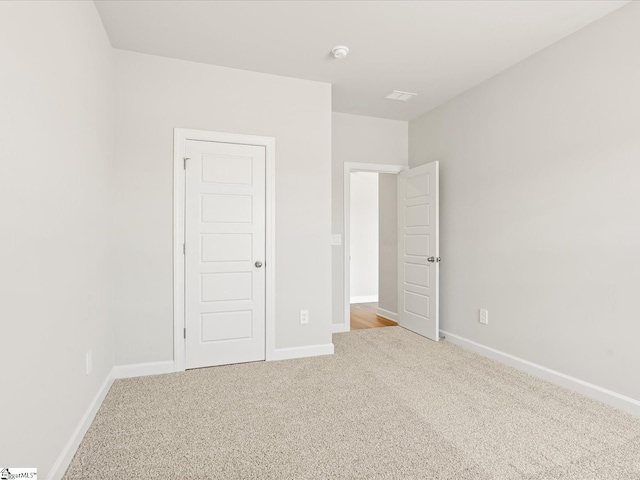 unfurnished bedroom with carpet and baseboards