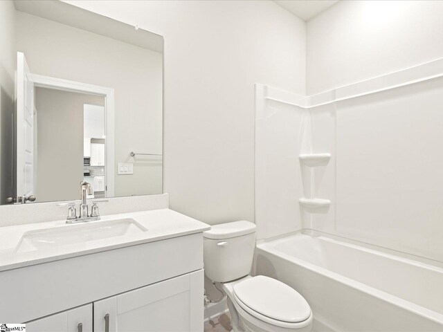 bathroom featuring vanity, toilet, and bathing tub / shower combination