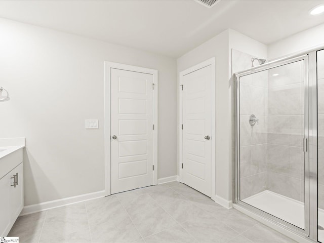 full bath featuring a shower stall, vanity, and tile patterned floors