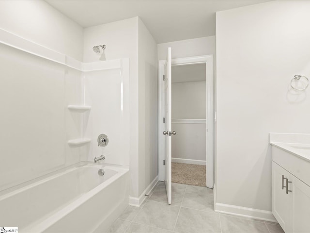 bathroom with baseboards, shower / bathing tub combination, vanity, and tile patterned floors