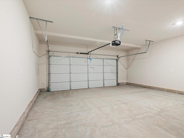 garage with baseboards and a garage door opener