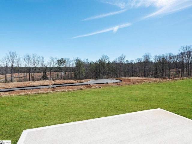 view of yard with a view of trees