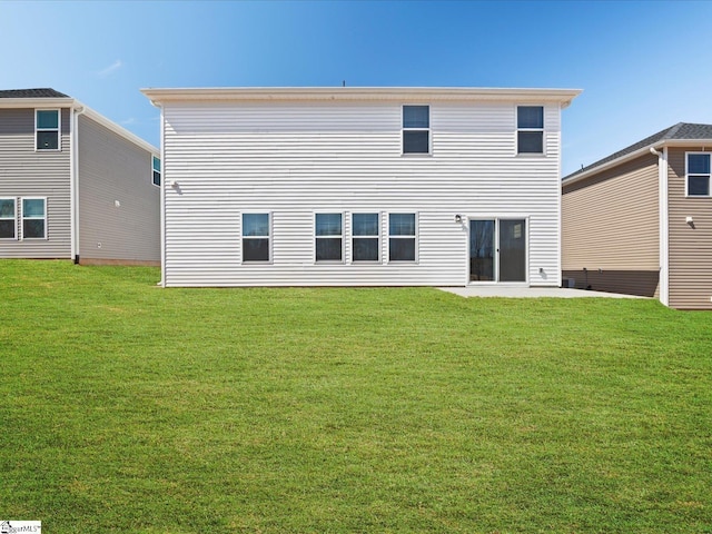 back of property featuring a patio area and a yard