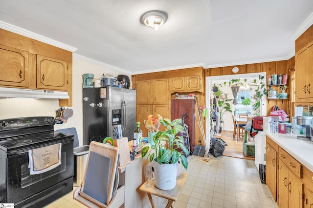 kitchen with stainless steel fridge, black range with electric stovetop, ornamental molding, and wood walls