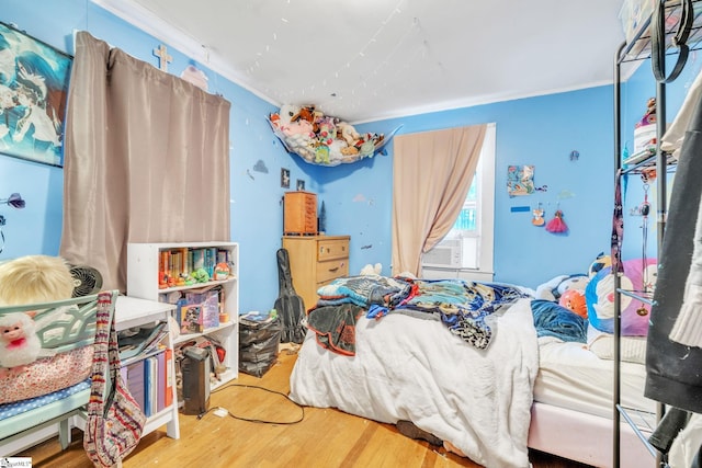 bedroom with wood-type flooring and crown molding