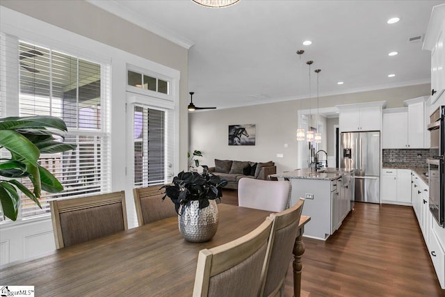 dining space with ceiling fan, plenty of natural light, and ornamental molding