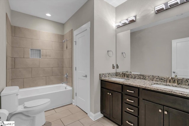 full bathroom featuring tile patterned flooring, tiled shower / bath combo, toilet, and vanity