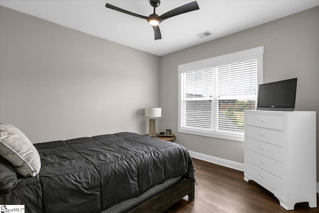 bedroom featuring ceiling fan and dark hardwood / wood-style floors