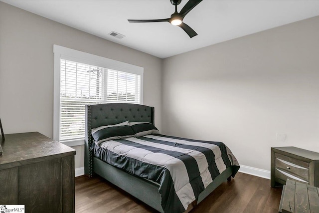 bedroom with ceiling fan and dark wood-type flooring