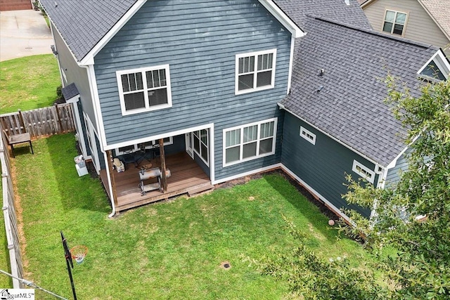 rear view of house with a yard and a deck