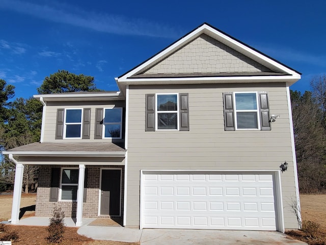 view of front of property featuring covered porch and a garage