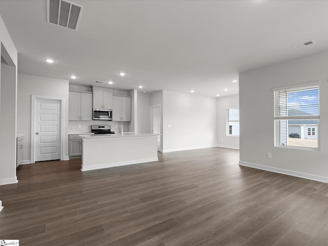 unfurnished living room with dark wood-type flooring