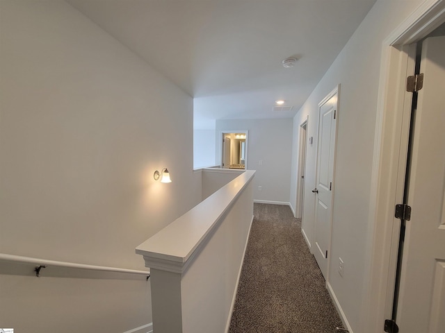 hallway with dark carpet