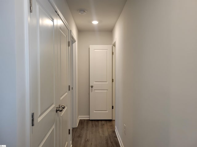 corridor with dark hardwood / wood-style floors