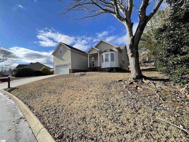 single story home featuring concrete driveway and an attached garage