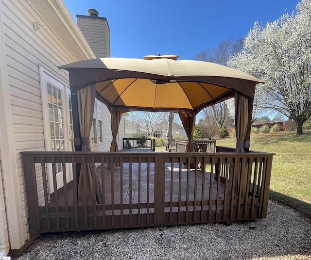 wooden terrace featuring a gazebo