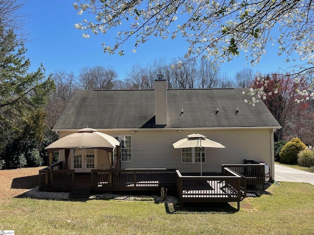 back of house featuring french doors, a yard, and a deck