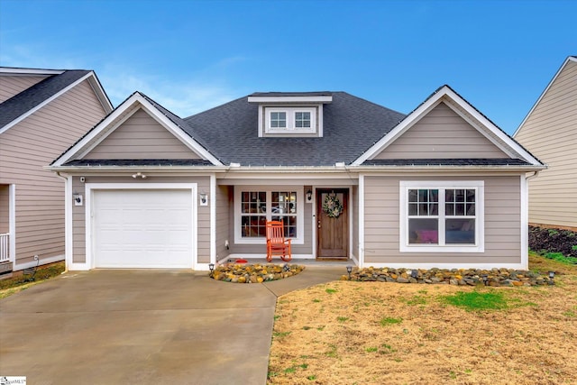 view of front of house featuring a front lawn, covered porch, and a garage