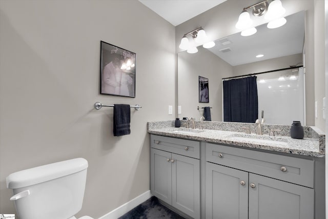 bathroom featuring vanity, toilet, and curtained shower