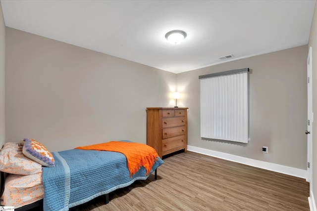 bedroom with hardwood / wood-style flooring