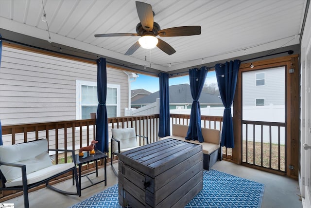 sunroom / solarium featuring ceiling fan