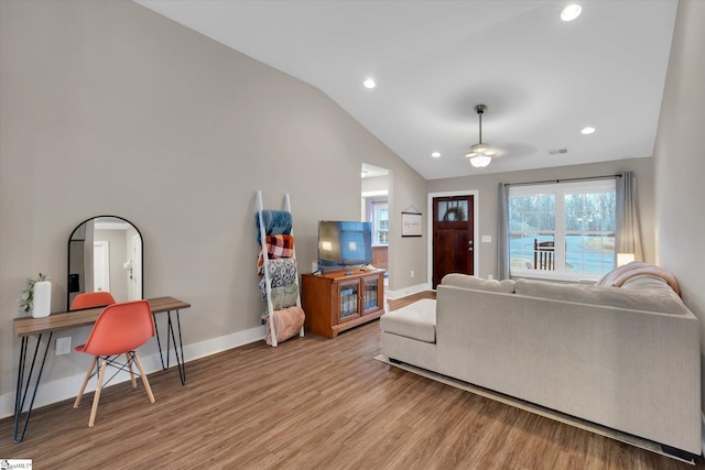 living room with light hardwood / wood-style flooring and lofted ceiling