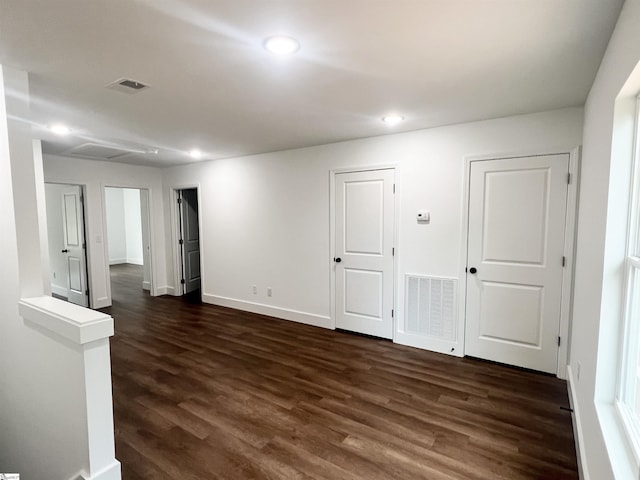 unfurnished room with dark wood-type flooring