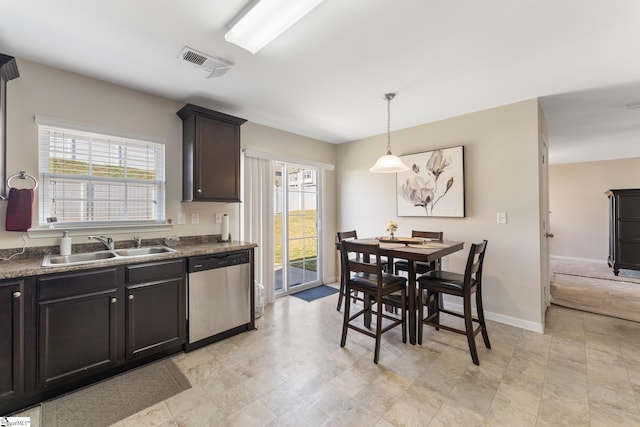 kitchen with stainless steel dishwasher, decorative light fixtures, plenty of natural light, and sink