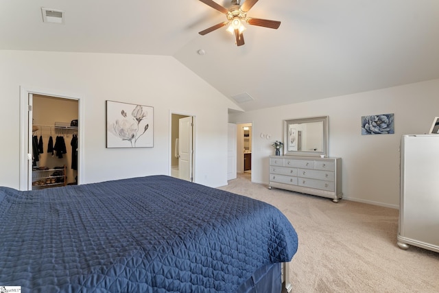 bedroom featuring vaulted ceiling, ceiling fan, a spacious closet, light colored carpet, and a closet