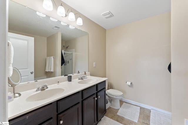 bathroom featuring vanity, an enclosed shower, and toilet