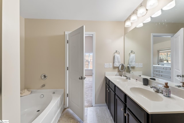 bathroom with tile patterned floors, vanity, and a tub