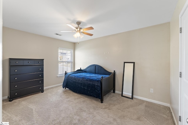 bedroom with ceiling fan and light carpet