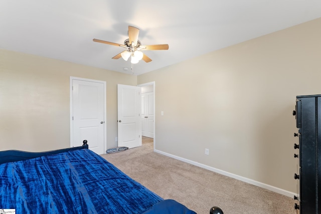 unfurnished bedroom featuring light carpet and ceiling fan