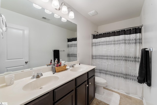 full bathroom featuring tile patterned floors, vanity, toilet, and shower / bath combo with shower curtain