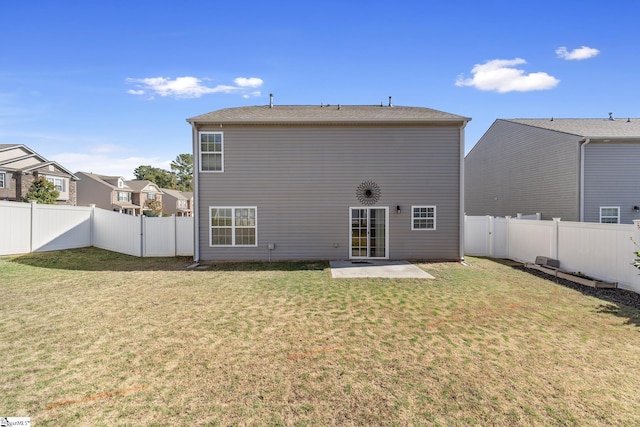 rear view of property featuring a yard and a patio