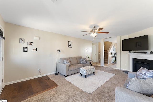 living room featuring ceiling fan and light carpet