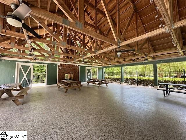 misc room featuring beam ceiling, a healthy amount of sunlight, and high vaulted ceiling