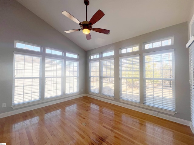 spare room with ceiling fan, light hardwood / wood-style floors, a wealth of natural light, and vaulted ceiling