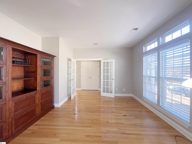 interior space with french doors and light wood-type flooring