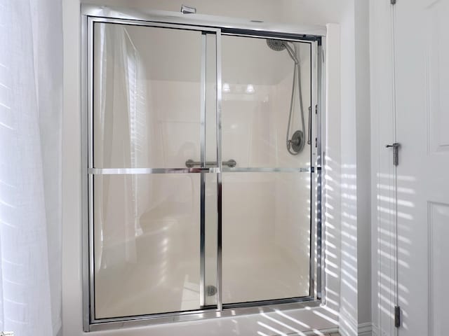 bathroom with a shower with shower door