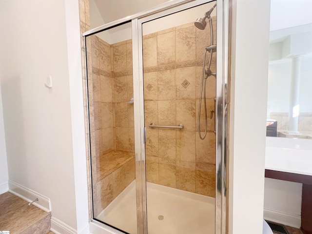 bathroom featuring a shower with shower door