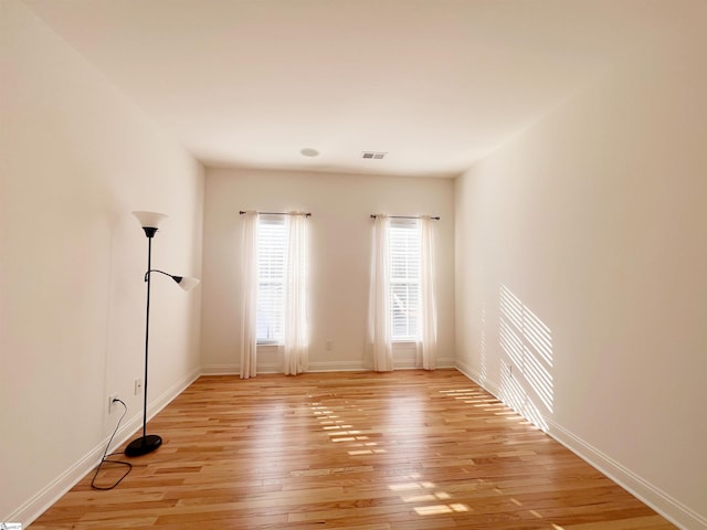 spare room featuring light wood-type flooring