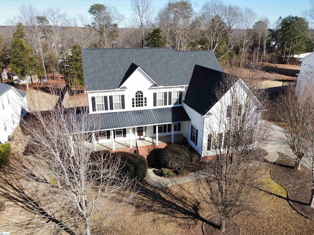 back of property featuring covered porch