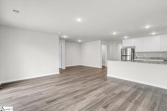 unfurnished living room featuring light hardwood / wood-style flooring