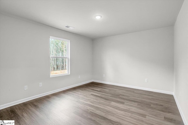 spare room featuring hardwood / wood-style floors